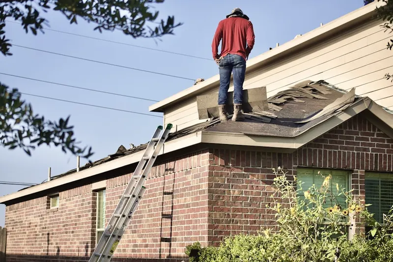 Professional roofer working on a residential roof in Little Ferry